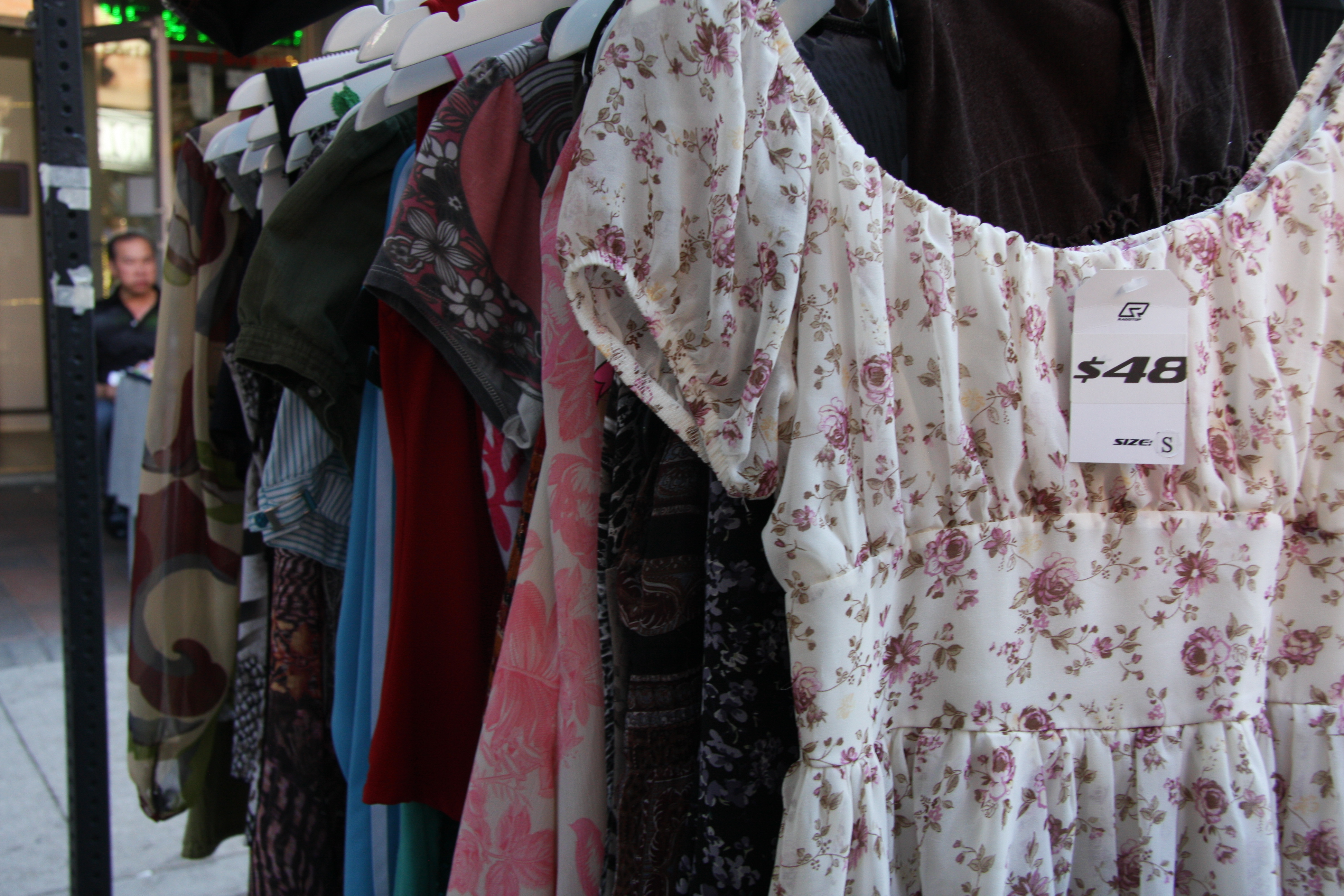 A rack display of floral and sequined y2k clothes